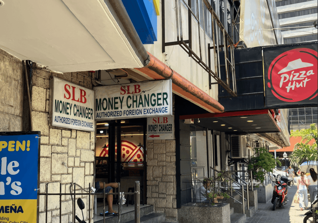 セブ島の街中にある「SLB MONEY CHANGER」の外観と隣接するピザハットの店舗